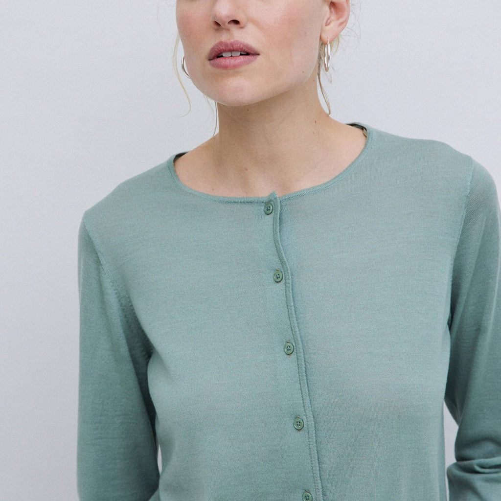 Soft blue green merino wool cardigan with full length sleeves and button front. 