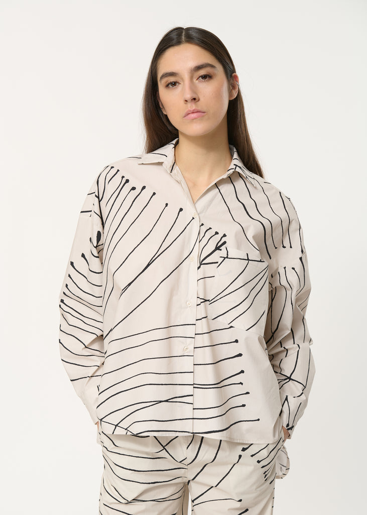 Oversized leaf printed cream shirt with 
long sleeves with buttoned cuffs