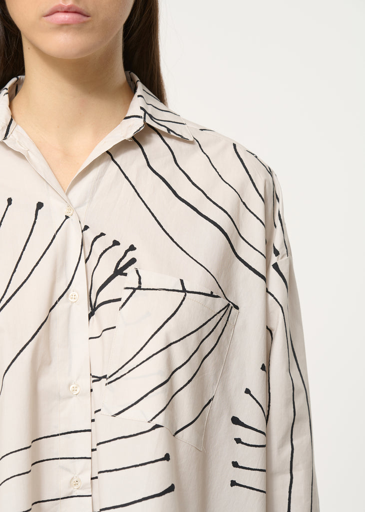 Oversized leaf printed cream shirt with 
long sleeves with buttoned cuffs