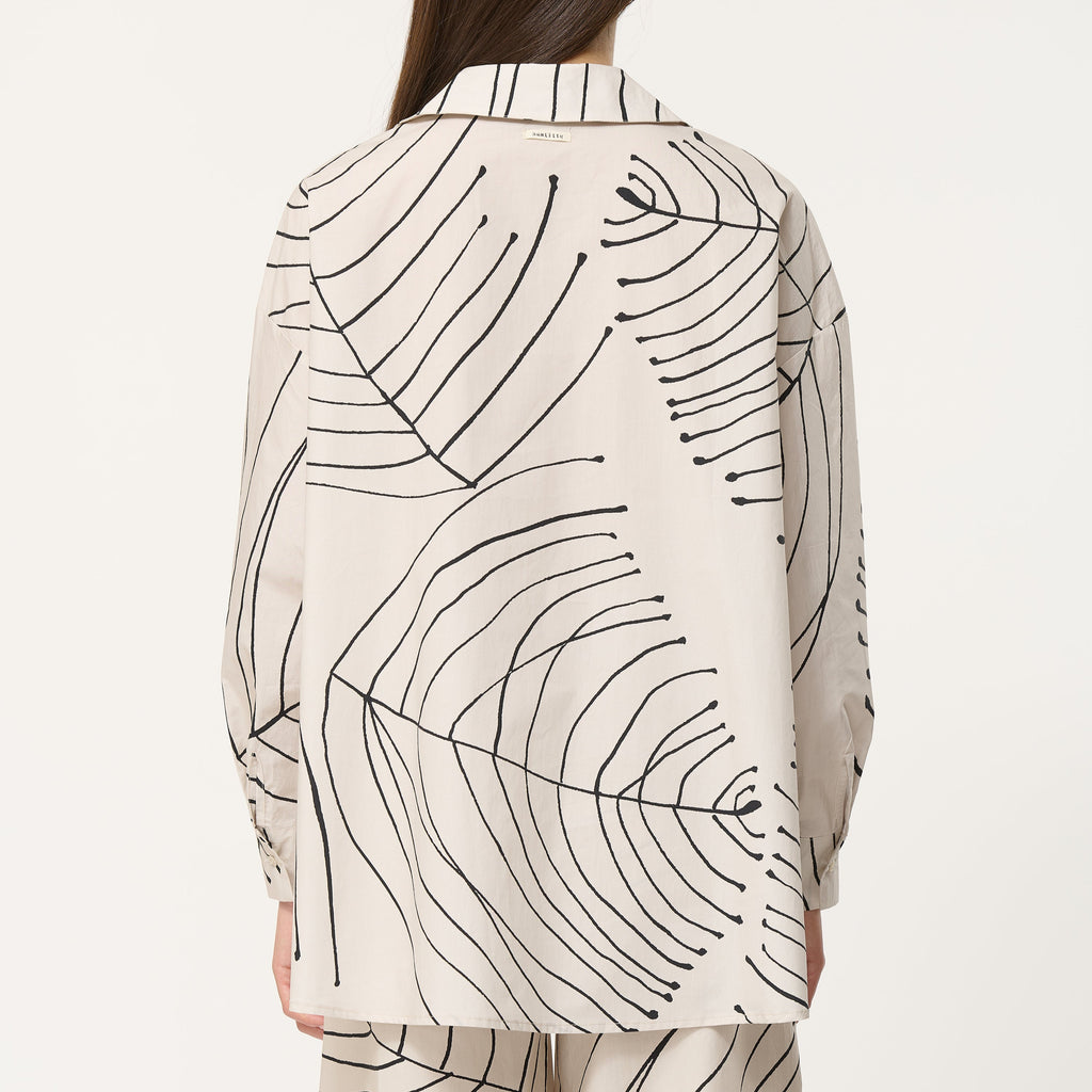 Oversized leaf printed cream shirt with 
long sleeves with buttoned cuffs