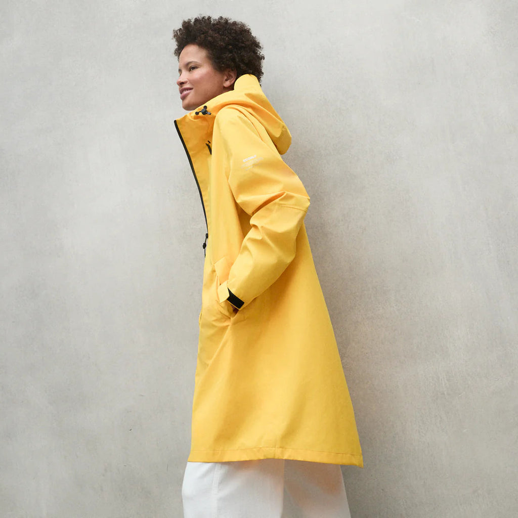 Model in a bright yellow Ecoalf jacket with black accents, standing against a neutral background.